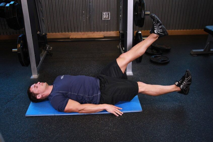 E Mann mat Prostatitis mécht eng Übung am Fitnessstudio